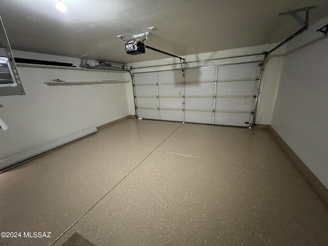 garage with a garage door opener and baseboards