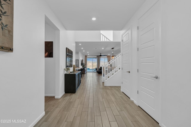 8111 S Soltero Mine Dr, Tucson, AZ 85747 - corridor with light wood finished floors, recessed lighting, and stairway