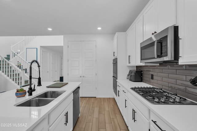 8111 S Soltero Mine Dr, Tucson, AZ 85747 - kitchen with appliances with stainless steel finishes, light countertops, light wood-type flooring, and recessed lighting