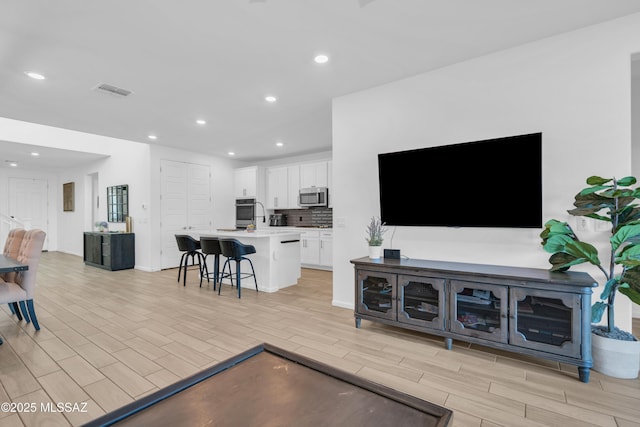 8111 S Soltero Mine Dr, Tucson, AZ 85747 - living area with wood finish floors and recessed lighting