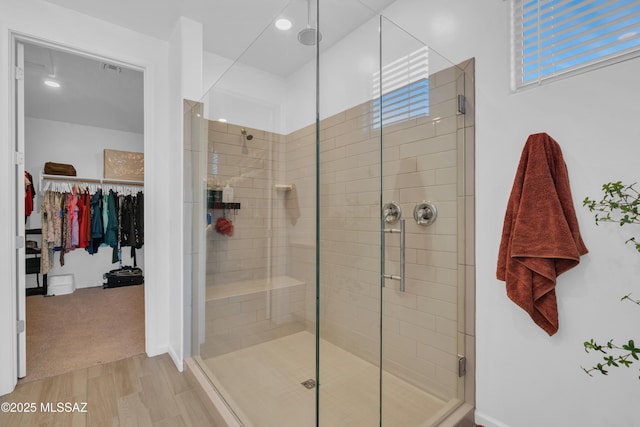 8111 S Soltero Mine Dr, Tucson, AZ 85747 - full bathroom featuring a shower stall, a spacious closet, and wood finished floors