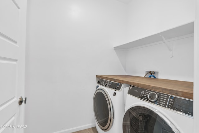 8111 S Soltero Mine Dr, Tucson, AZ 85747 - laundry area with washing machine and dryer and wood finished floors
