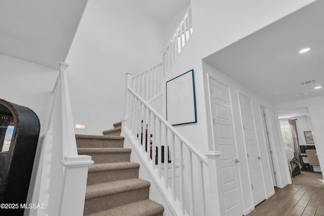 8111 S Soltero Mine Dr, Tucson, AZ 85747 - stairway with wood finished floors and recessed lighting