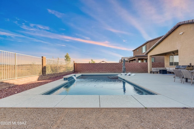 8111 S Soltero Mine Dr, Tucson, AZ 85747 - pool at dusk with a fenced backyard, an outdoor living space, and a patio area
