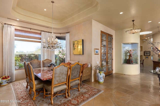 dining room featuring a chandelier, recessed lighting, and a raised ceiling