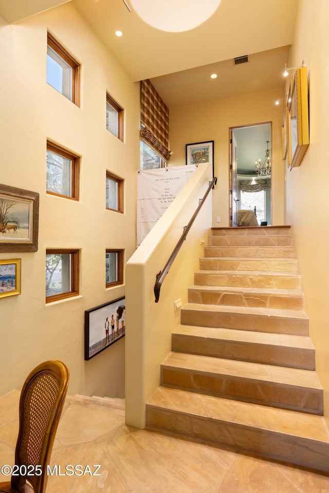 stairs featuring plenty of natural light, visible vents, and recessed lighting