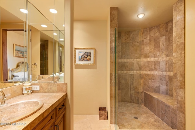 bathroom with a stall shower, recessed lighting, and vanity