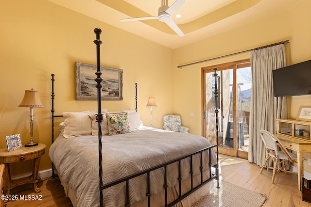 bedroom with baseboards, access to exterior, and light wood-type flooring
