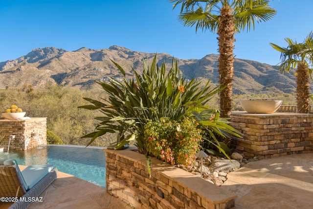 view of pool with a mountain view