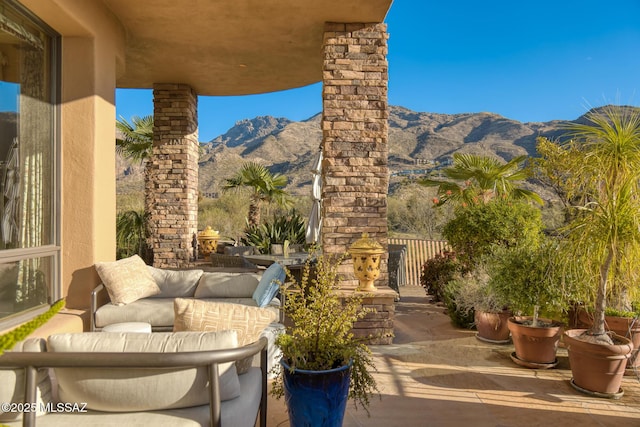 view of patio featuring an outdoor living space and a mountain view