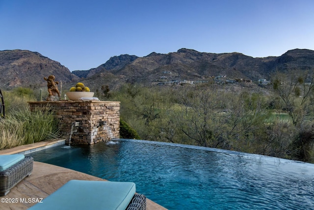 view of pool with a mountain view