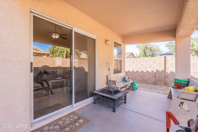 view of patio / terrace with an outdoor fire pit and fence