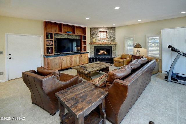 living room with a stone fireplace, recessed lighting, and light tile patterned floors