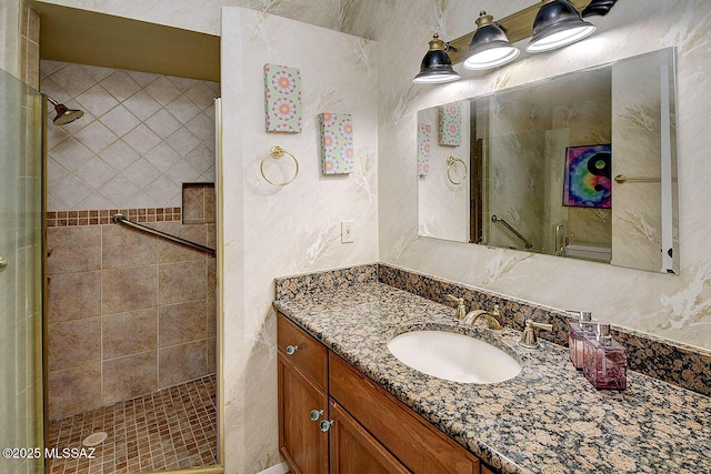 bathroom featuring a stall shower and vanity