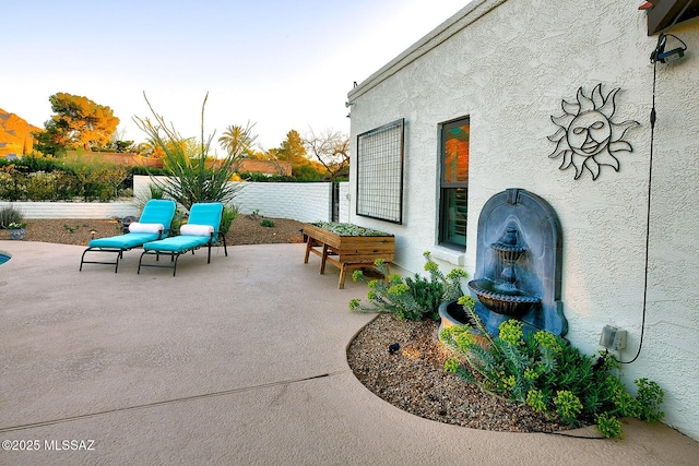view of patio / terrace featuring fence