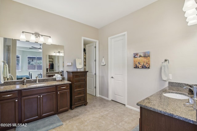 bathroom with two vanities, a sink, and tile patterned flooring