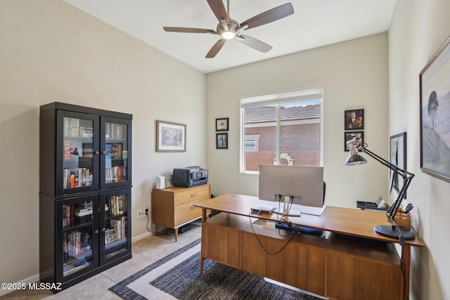 office area with ceiling fan, baseboards, and light tile patterned floors