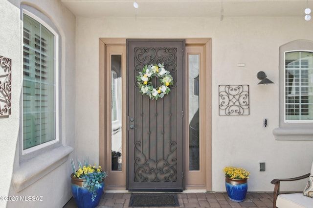 entrance to property with stucco siding