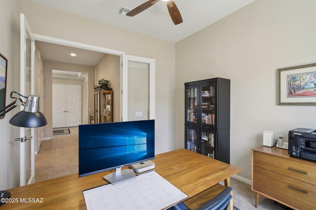 office with tile patterned floors, a ceiling fan, and baseboards