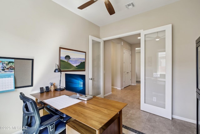 office area with visible vents, baseboards, a ceiling fan, and light tile patterned flooring