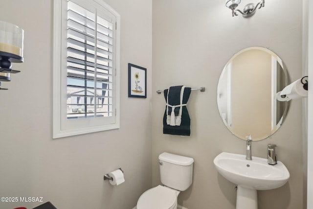 half bathroom featuring a sink and toilet