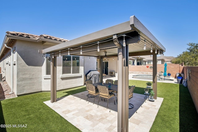 view of patio / terrace featuring a fenced in pool, a fenced backyard, ceiling fan, and outdoor dining space