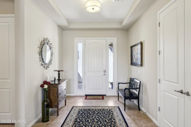 foyer entrance with light tile patterned floors, visible vents, and baseboards