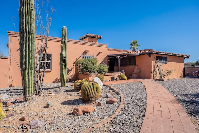 view of front of home featuring a tiled roof and stucco siding
