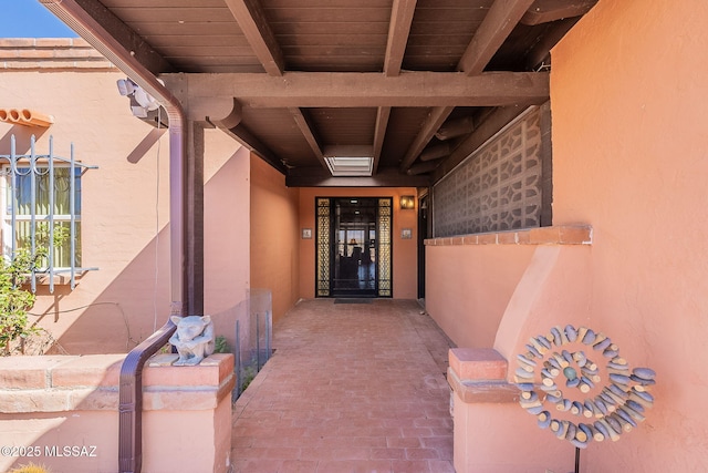 doorway to property featuring stucco siding