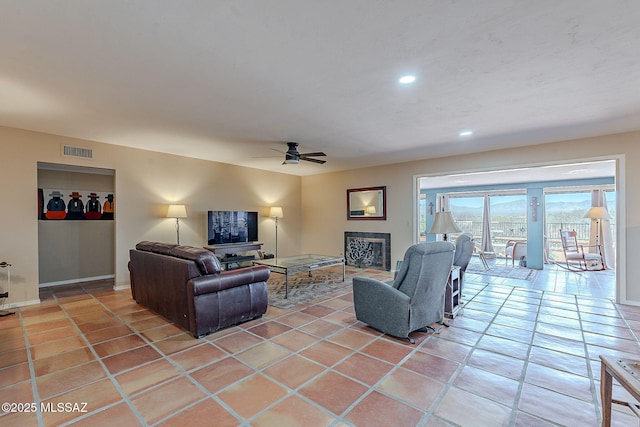 living area featuring visible vents, light tile patterned floors, recessed lighting, a fireplace, and a ceiling fan