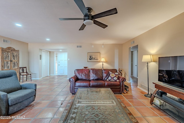 living area with light tile patterned floors, visible vents, baseboards, and ceiling fan