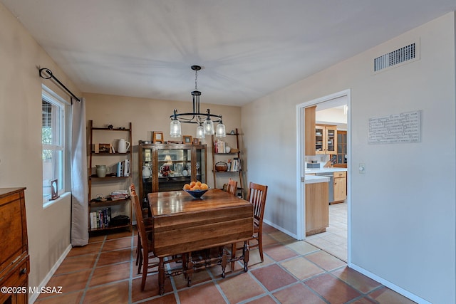 dining room with an inviting chandelier, light tile patterned flooring, baseboards, and visible vents