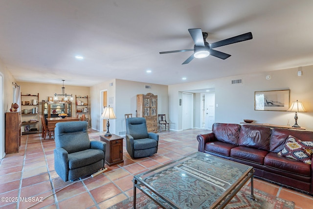 living room featuring recessed lighting, light tile patterned flooring, ceiling fan with notable chandelier, and visible vents