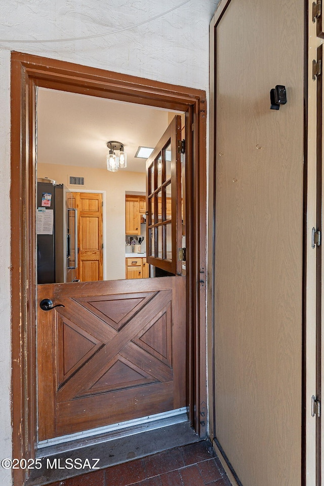 view of exterior entry with visible vents