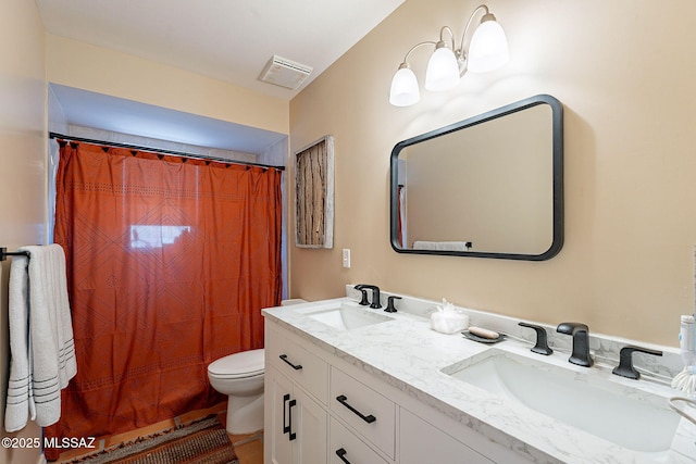 full bath with double vanity, visible vents, toilet, and a sink