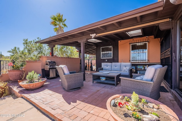 view of patio featuring grilling area, fence, and an outdoor hangout area