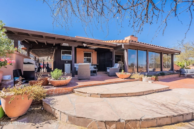 view of patio featuring a sunroom