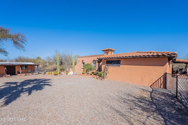 view of front of house with stucco siding and a tile roof