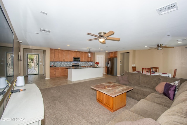 living area with light colored carpet, visible vents, ceiling fan, and recessed lighting