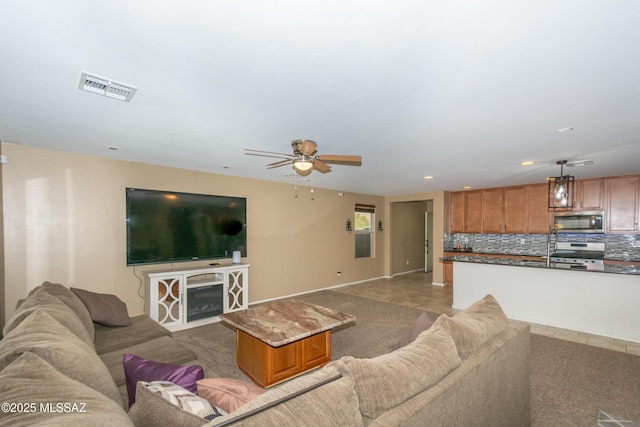 living room featuring a ceiling fan, recessed lighting, a fireplace, and visible vents