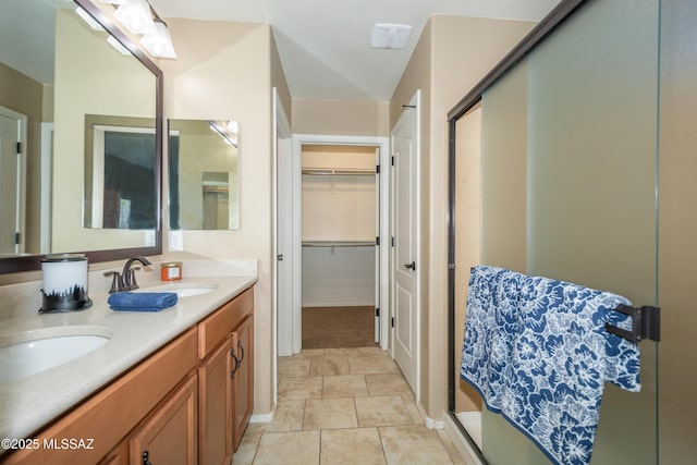 full bathroom with double vanity, a sink, and a shower stall