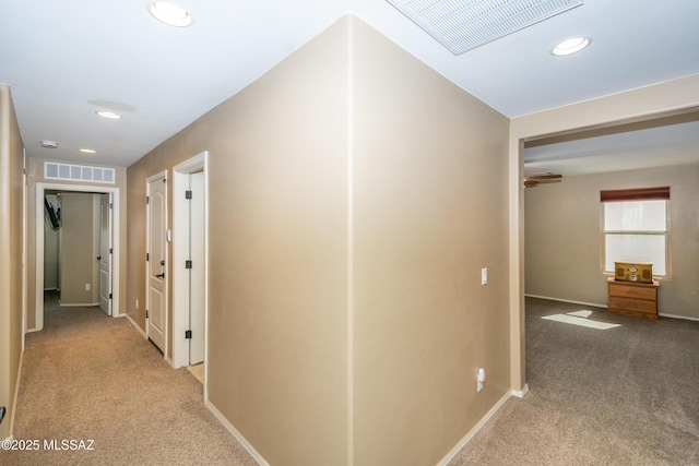 hall with carpet flooring, visible vents, and recessed lighting