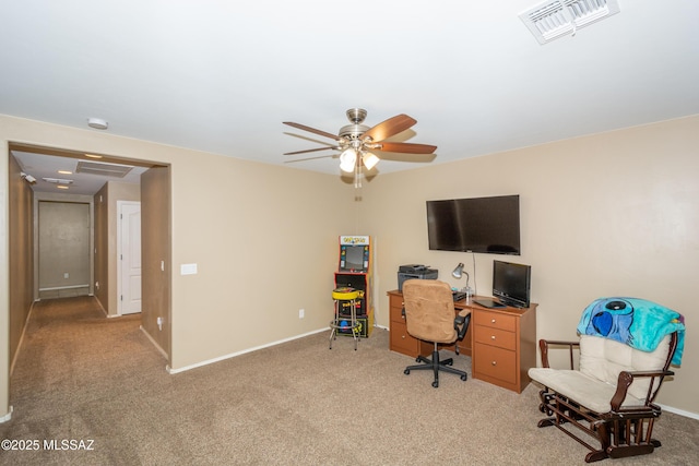 carpeted office space with baseboards, visible vents, and a ceiling fan