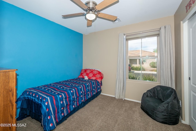 bedroom with baseboards, visible vents, carpet flooring, and a ceiling fan