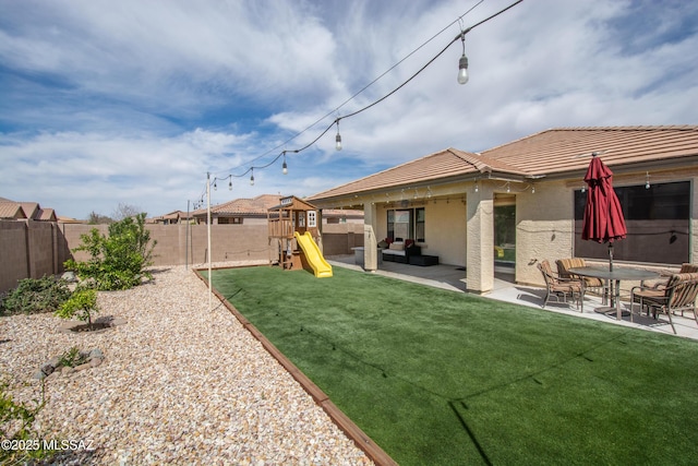 view of yard featuring a fenced backyard, an outdoor hangout area, a patio, and a playground