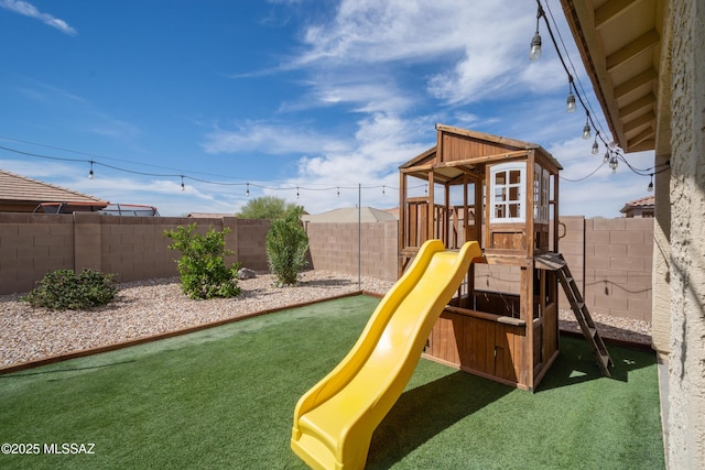 view of playground with a fenced backyard