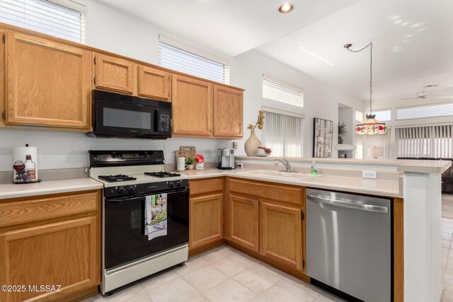 kitchen featuring range with gas cooktop, a sink, dishwasher, a peninsula, and black microwave