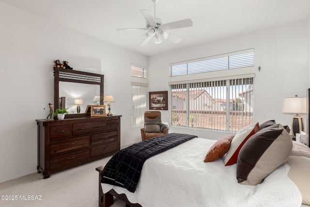 bedroom featuring a ceiling fan and light carpet