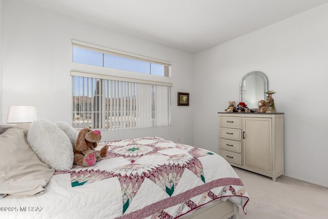 bedroom with light colored carpet