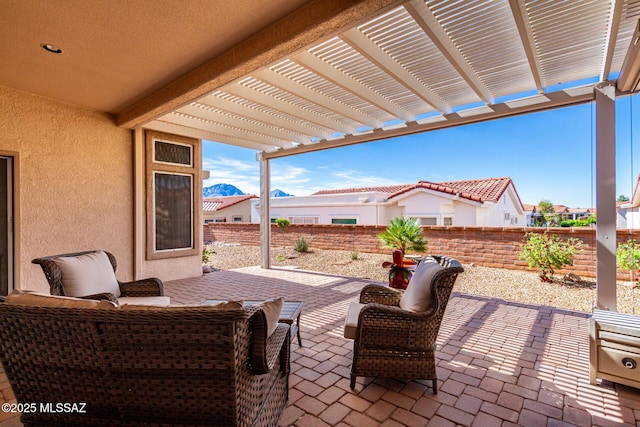 view of patio / terrace with an outdoor hangout area, a fenced backyard, and a pergola